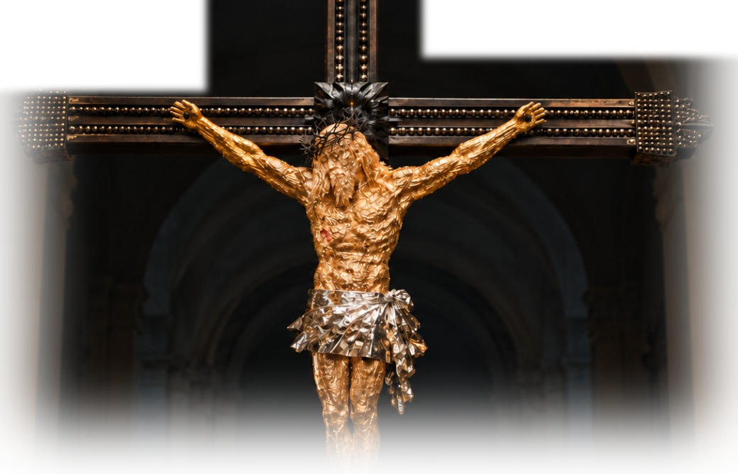 The Cross of Peace: a gilded figure of Christ on a dark cross, standing in a church